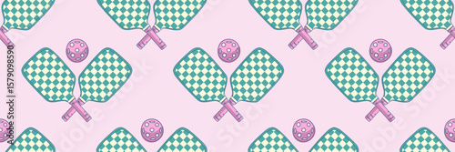Seamless pattern with turquoise pickleball rackets and balls on soft pink background. Great for textile prints, gift wrapping, wallpaper or background