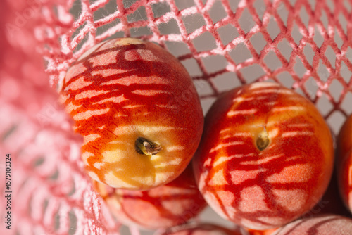 Wallpaper Mural Fresh peaches in a pink string bag close up. Healthy food concept. Eco friendly theme. Summer backdrop Torontodigital.ca