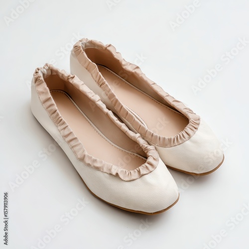 The ballet shoes are made from a soft white leather with a ru ru