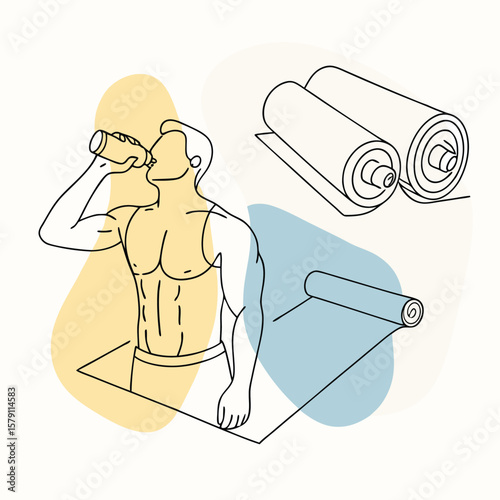 Shirtless athletic man drinks water standing near a yoga mat and rolled mats
