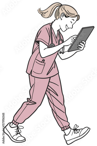 Smiling young blonde nurse in scrubs is walking while looking at a tablet