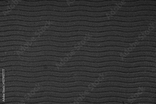 Schwarze Gummitextur mit welligem Oberflächenmuster