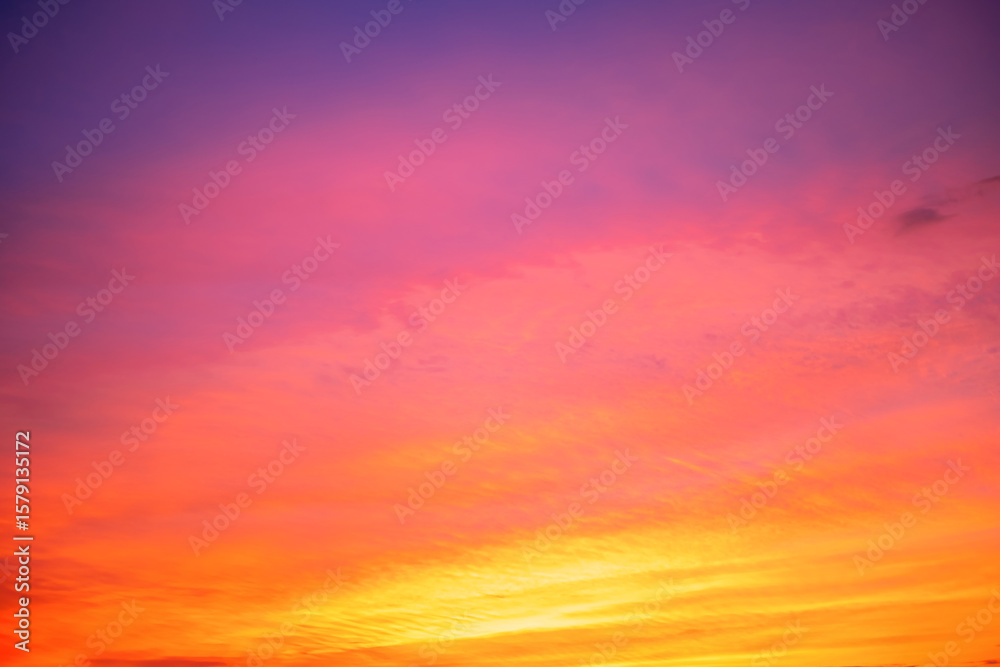 Obraz premium Beautiful , luxury soft gradient orange gold clouds and sunlight on the blue sky perfect for the background, take in evening,Twilight, Large size, high definition landscape photo