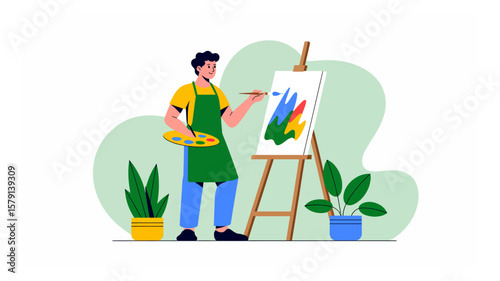 A young artist in a green apron creates a colorful abstract painting on a canvas with plants, showcasing creativity and passion in his art studio environment