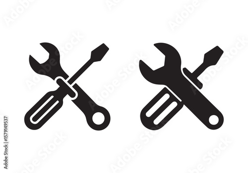 Two black silhouette icons of a wrench and screwdriver crossed isolated on white background