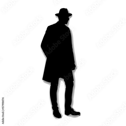 Silhouette of a man wearing a hat and coat standing confidently  