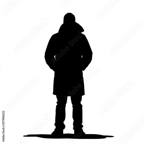 Silhouette of a man standing with hands in pockets in winter coat  