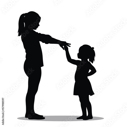 Silhouette of girl teaching younger sister with hand gesture  