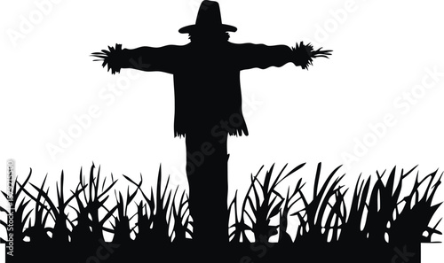 Silhouette of Scarecrow Standing in a Field of Grass