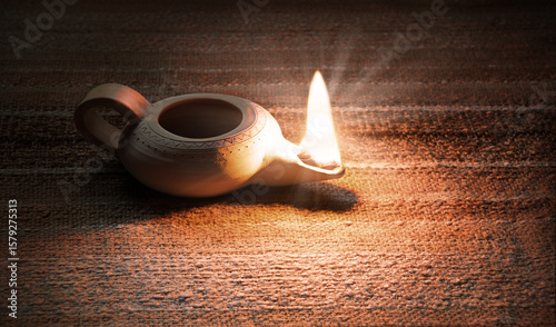 Foto Ancient lamp shines in the dark