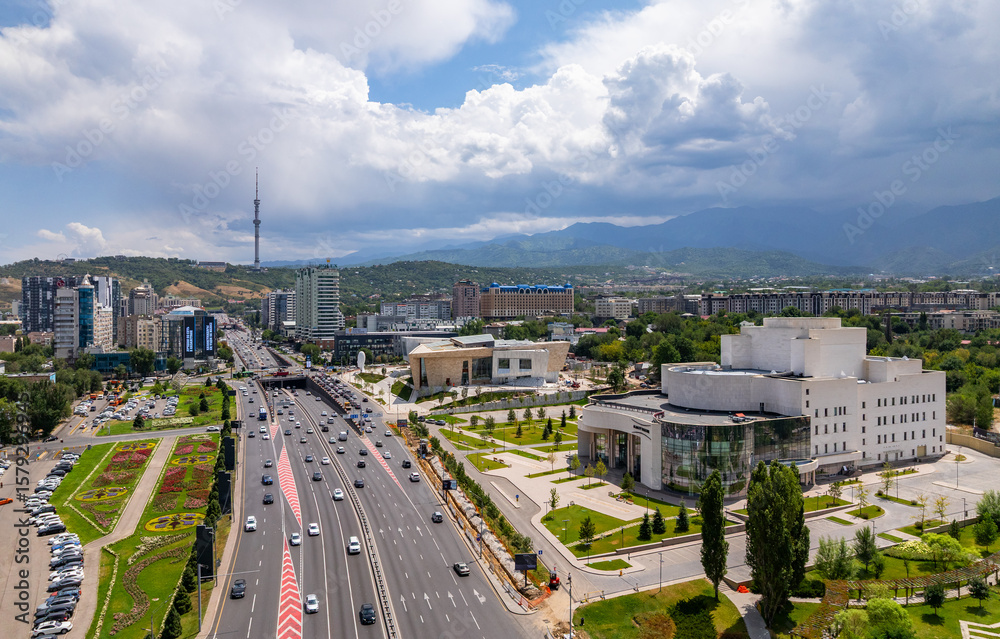 Obraz premium Al-Farabi Prospect in the business center of the Kazakh city of Almaty, buildings of the new theatre and museum of modern art on a summer day