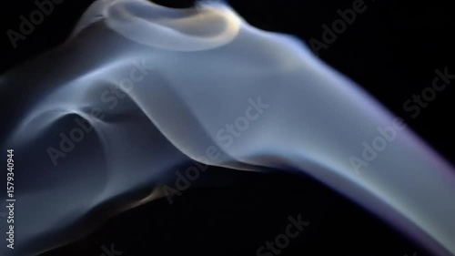 Abstract smoke waves flowing gracefully on black background  