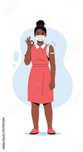 Young woman shows arm after receiving vaccination giving okay gesture