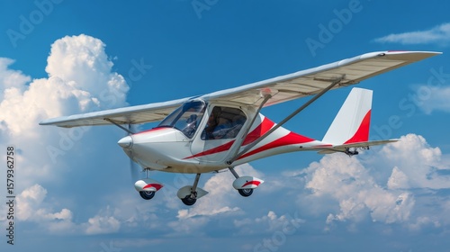 Sleek ultralight aircraft soaring in a clear blue sky