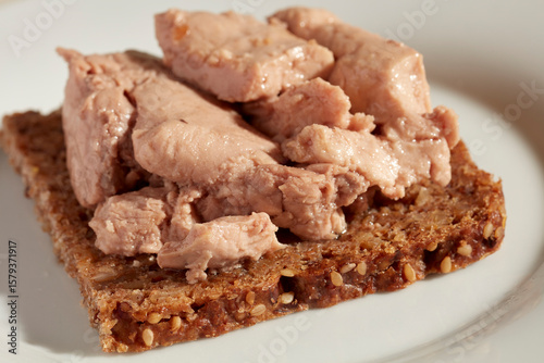 Canvas Print An open face cod liver sandwich on pumpernickel bread