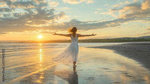 Woman embracing sunset on beach