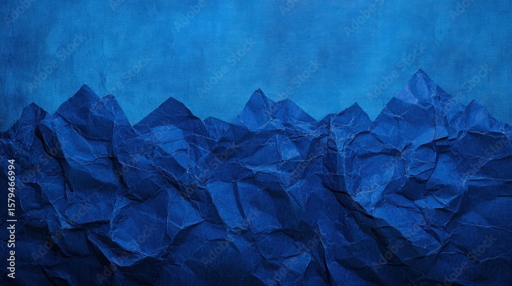 Naklejka premium Crinkled paper mountains against a deep blue sky