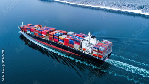A large container ship glides across calm waters, vibrant cargo containers set against wintery trees and a snowy shore, highlighting the beauty of maritime transport