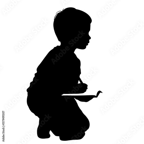 Silhouette of child kneeling and drawing in sketchbook  