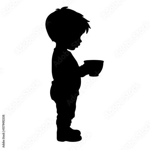 Silhouette of a child holding a bowl while standing sideways  
