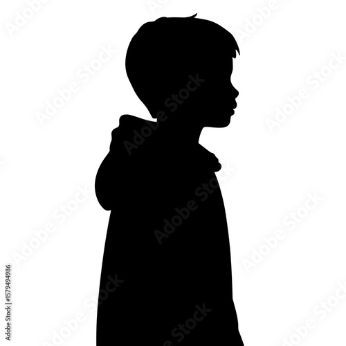 Silhouette of a boy standing quietly in a side profile view  