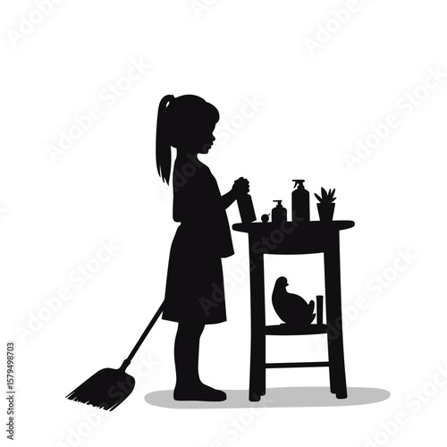 Young girl cleaning while standing by table with household items  