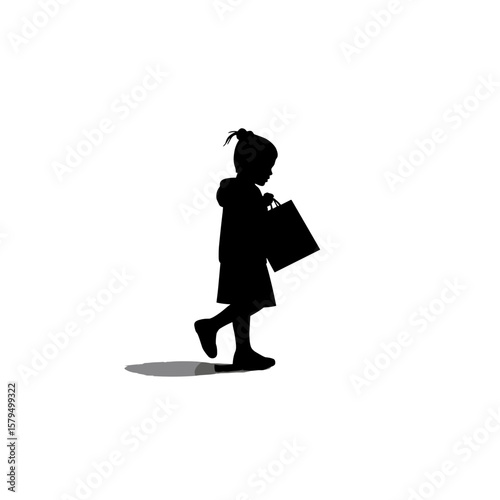 Silhouette of young girl walking while holding shopping bag  