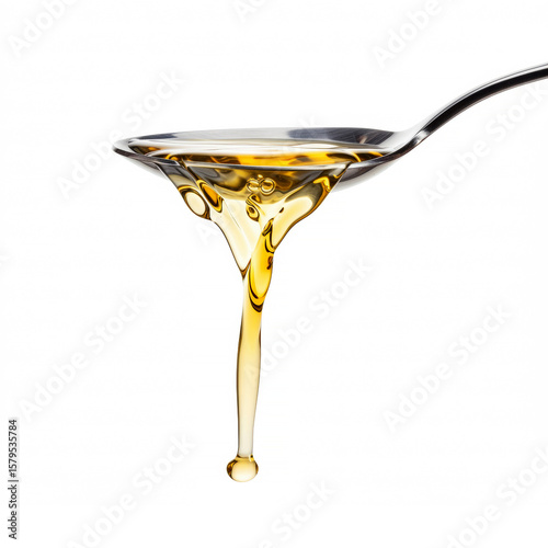 Pouring apple cider vinegar in a spoon isolated on white background