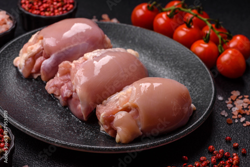 Raw chicken thigh fillet without skin and bone with salt and spices. Raw chicken fillet for cooking