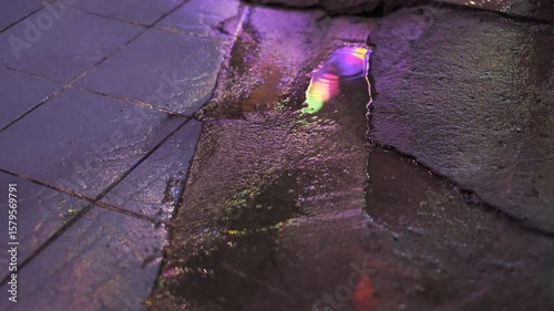 Wallpaper Mural A wet sidewalk with a reflection of a street light. The reflection is purple and the light is glowing Torontodigital.ca