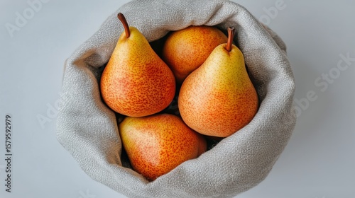 Fresh Ripe Pears in a Woven Basket on a Neutral Background