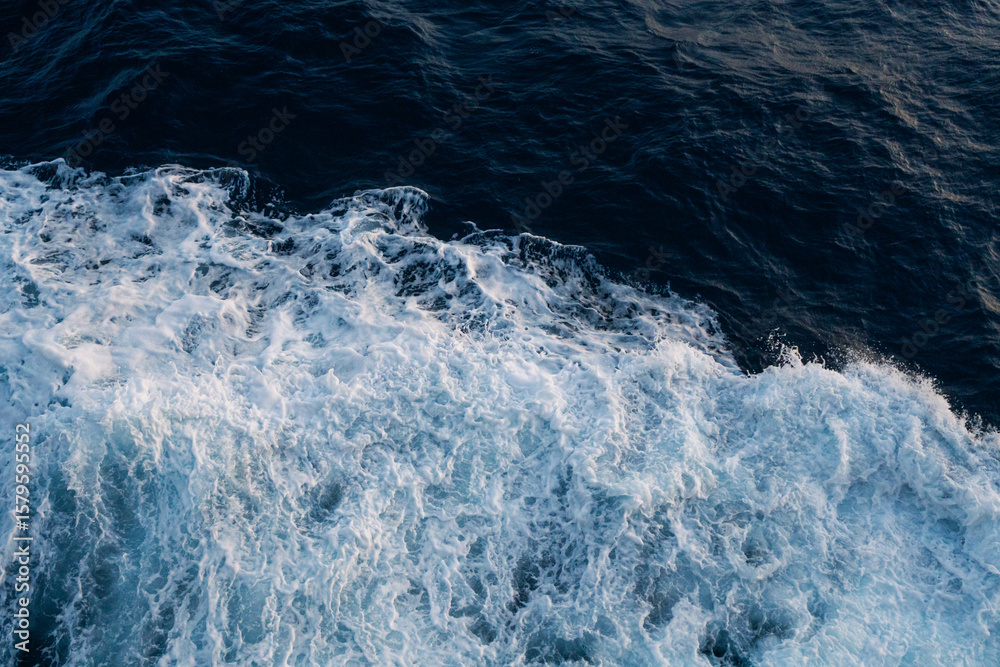 Fototapeta premium Sea water splash with foamy wave. Water surface texture. Tropical islands ferry travel. Cruiseliner trail. Ocean background. White water of sea. Marine travel banner template. Seaside vacation concept