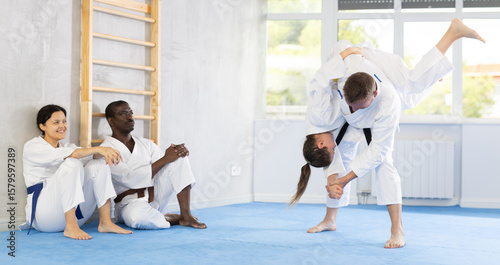In gym, cosmopolite athletes work in pairs and learn to use classic karate techniques to repel an opponents blow, hone melee skills, strengthen spirit. Sport as lifestyle.