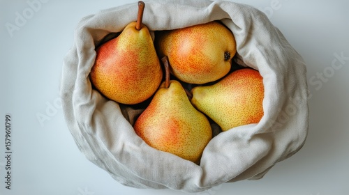 Fresh Ripe Pears Nestled in a Burlap Sack on a Light Background.
