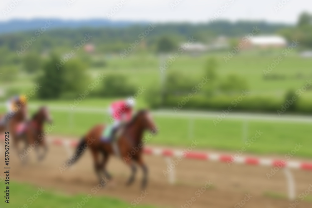 Obraz premium blurry racetrack, showing horses racing on a track with riders on them, blurry wallpaper.