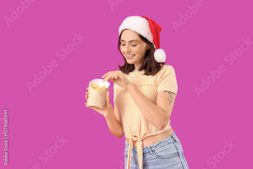 Young woman in Santa hat wi...
