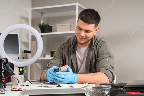 Male technician repairing m...