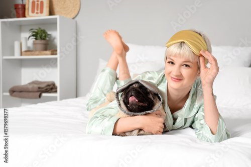 Young woman and pug dog wit...