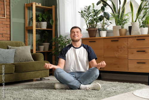 Young handsome man meditati...