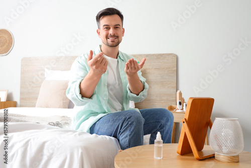Smiling young man sitting o...