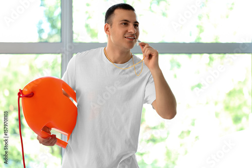 Happy male lifeguard with l...
