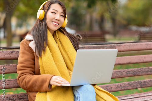 Smiling asian woman with ye...