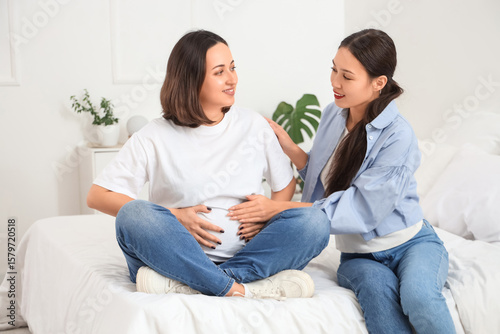 Young Asian doula with preg...