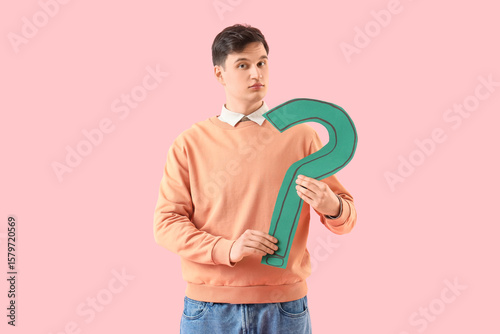 Young man with paper questi...