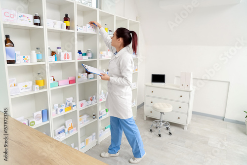Female pharmacist with clip...