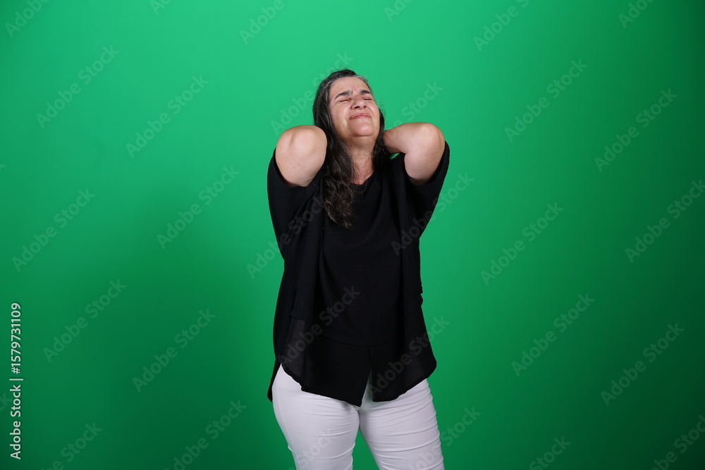 Fototapeta premium Unedited Portrait of Woman’s Face Expressing Various Emotions – Green Studio Background