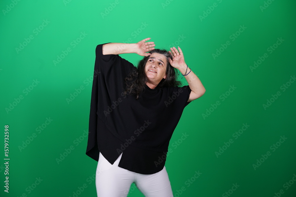 Fototapeta premium Unedited Portrait of Woman’s Face Expressing Various Emotions – Green Studio Background