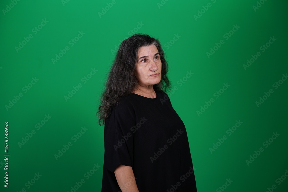Fototapeta premium Unedited Portrait of Woman’s Face Expressing Various Emotions – Green Studio Background