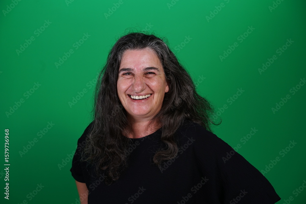 Fototapeta premium Unedited Portrait of Woman’s Face Expressing Various Emotions – Green Studio Background