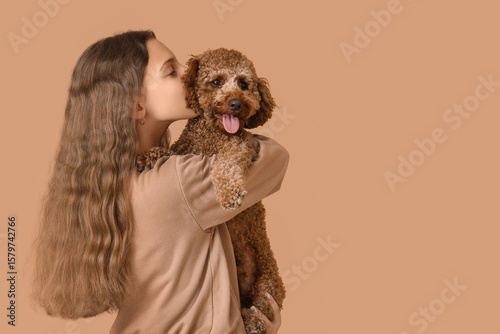 Teenage girl kissing Poodle...